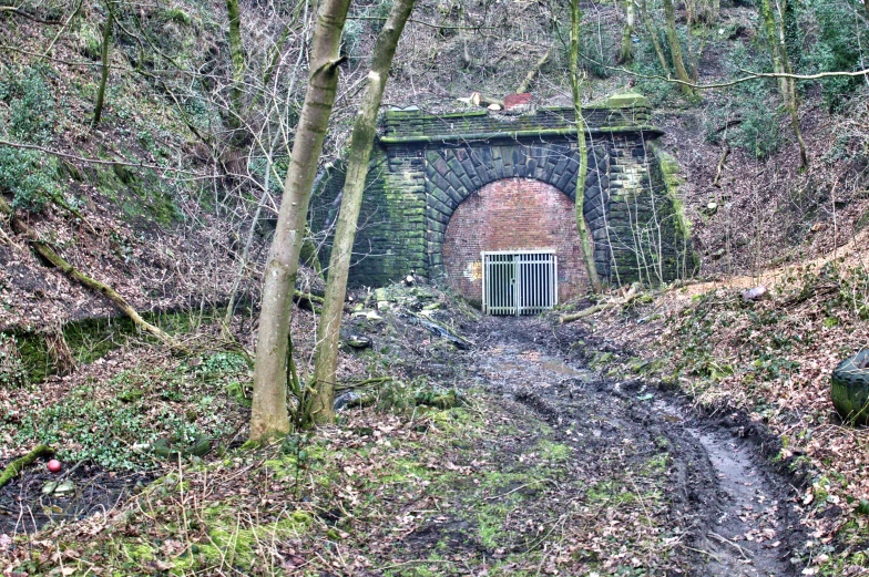 an old tunnel with a doorway and stairs