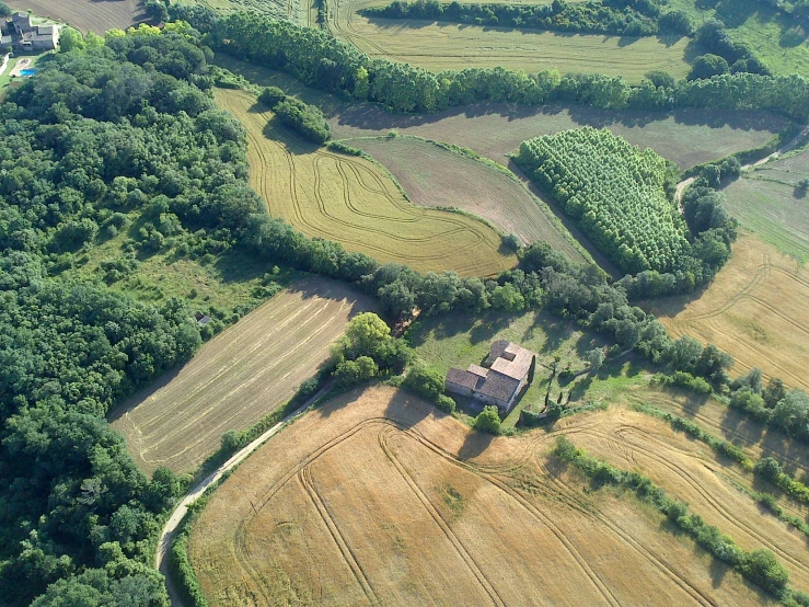 a house nestled between two landforms with trees