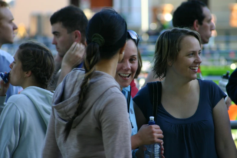 a group of people are laughing and drinking water