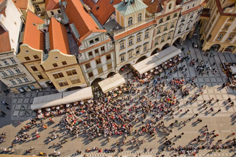 an aerial view of people walking around in front of buildings