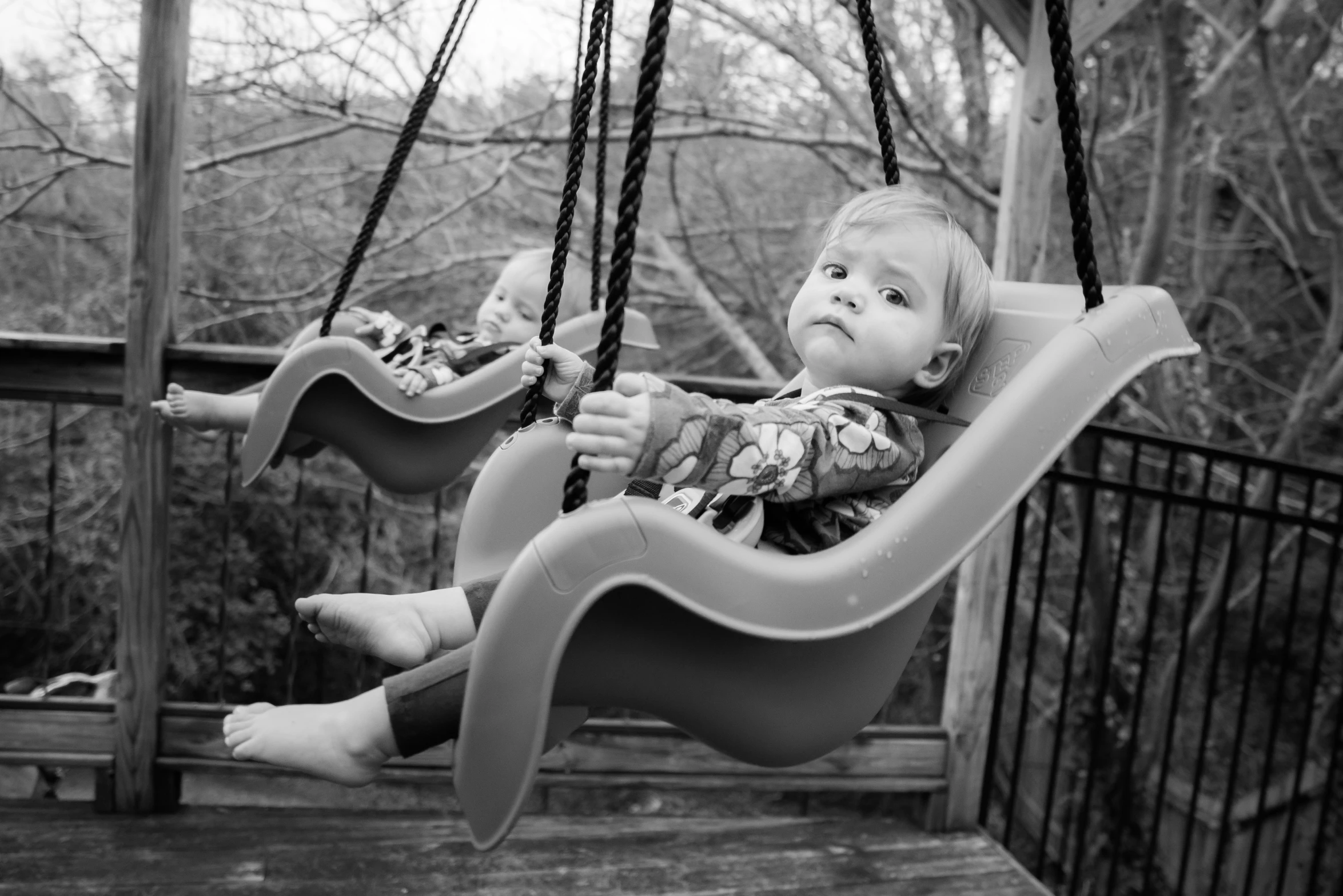 a child swinging at the park on a swing chair