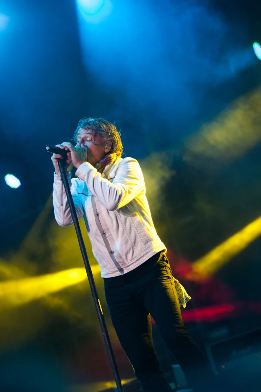 a man standing on a stage with a microphone