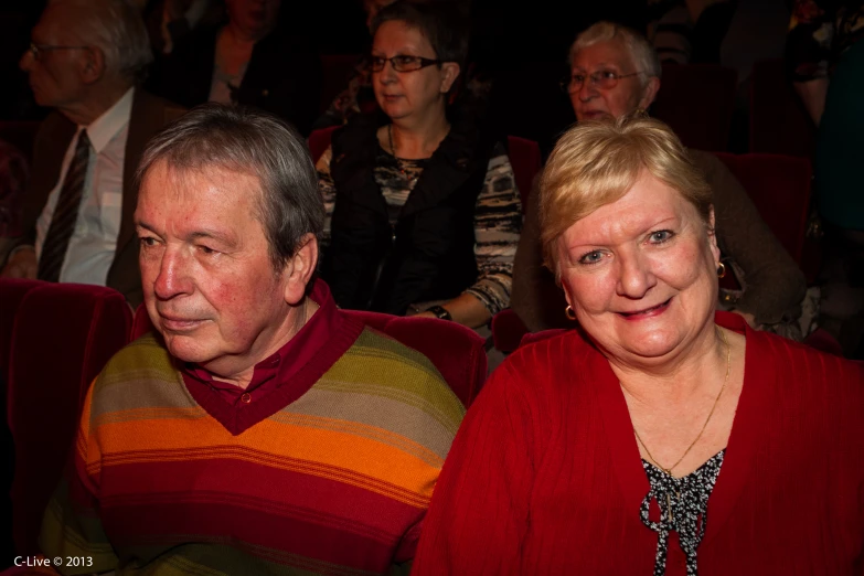 a close up of two people at a theater