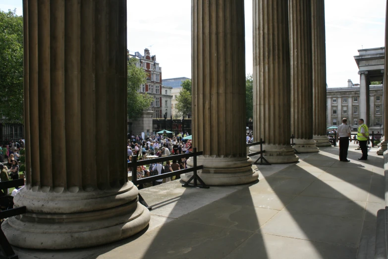 people are gathered around looking at columns