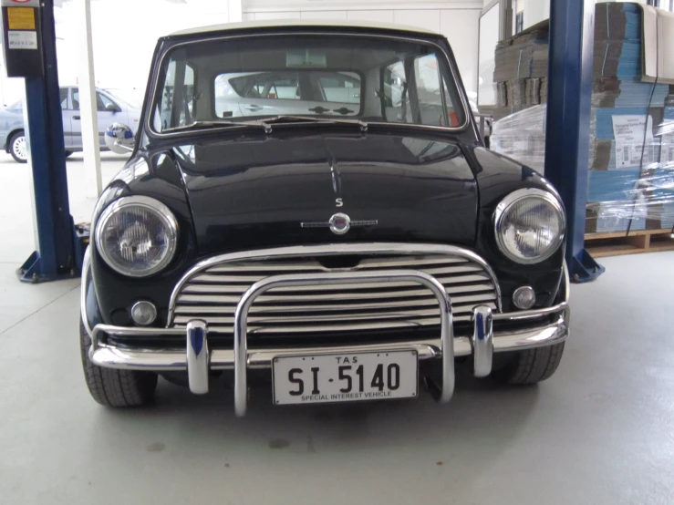 the front end of a black, vintage, station wagon