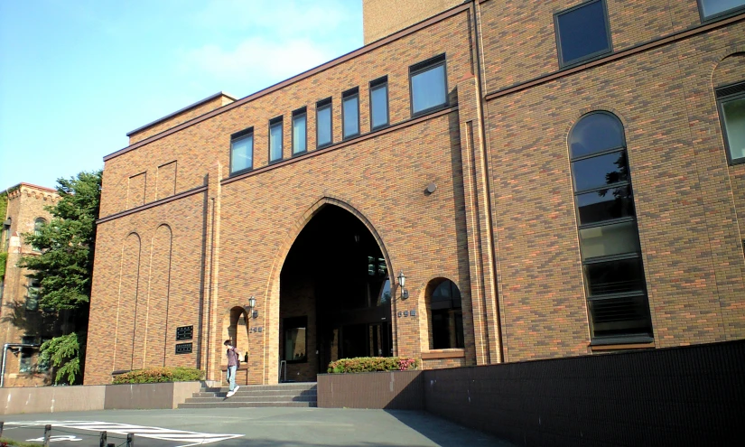 a large brick building with arches at the front entrance