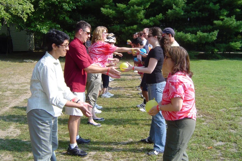 a group of people are getting water from their pitcher