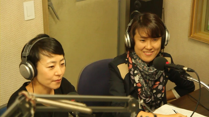an asian female and a japanese male wearing headphones