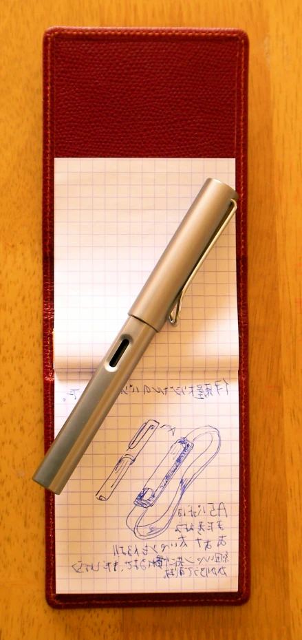 a notepad with writing paper and a fountain pen