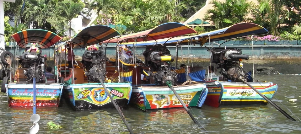 a line of water taxis with two motor bikes