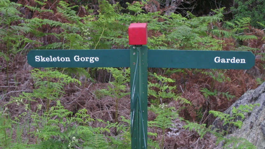 the street sign is telling the direction to the different towns