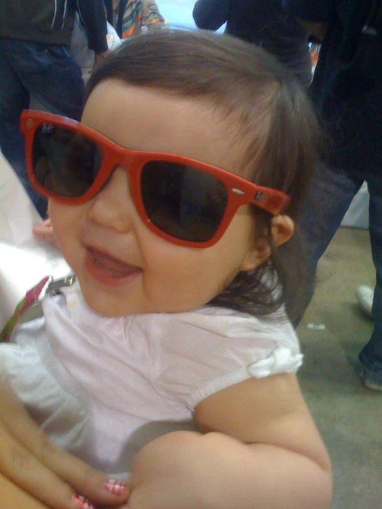 a baby in sunglasses poses for a po