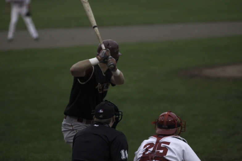 a baseball player is about to swing at the ball