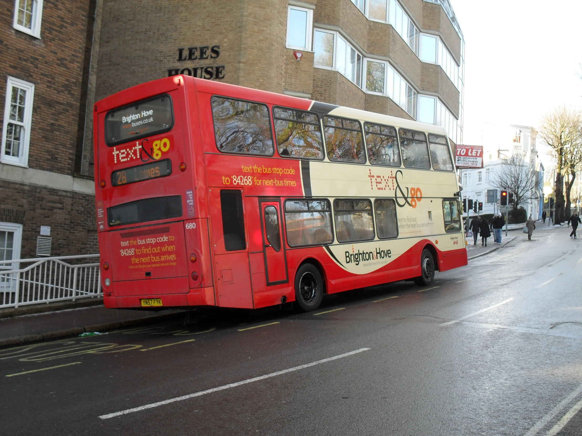 a double decker bus is parked next to a building