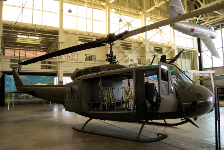 a black helicopter in an airplane hanger in a hangar