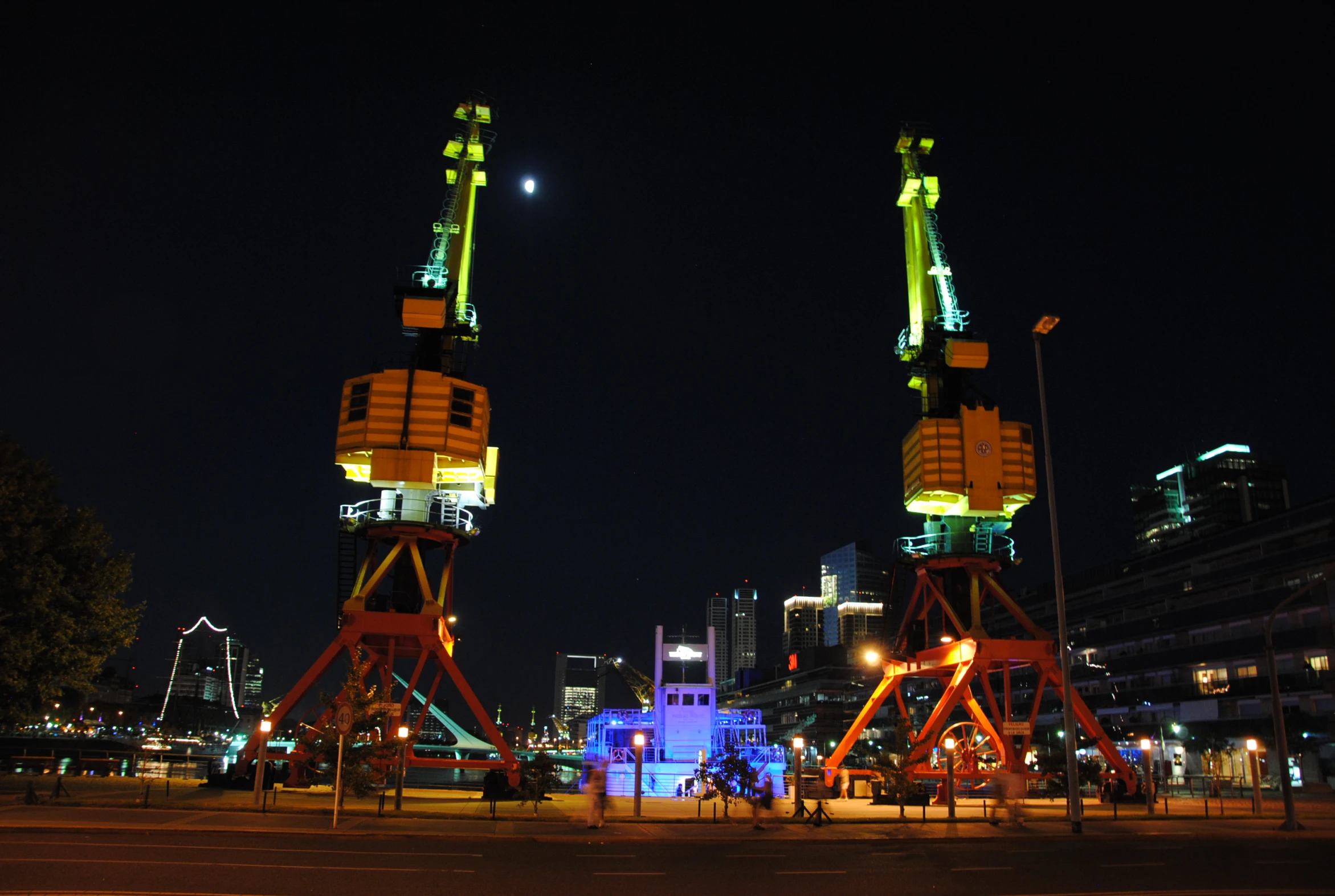 a city at night with two large tower towers