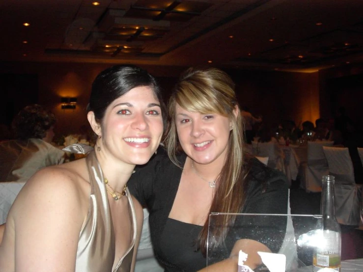 two women sit together at a table