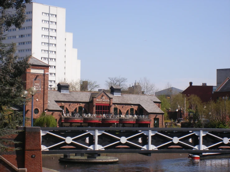 a bridge crossing a river with buildings in the background