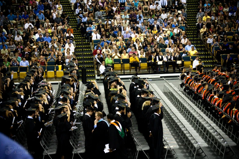 a number of graduates with many in black graduation gowns