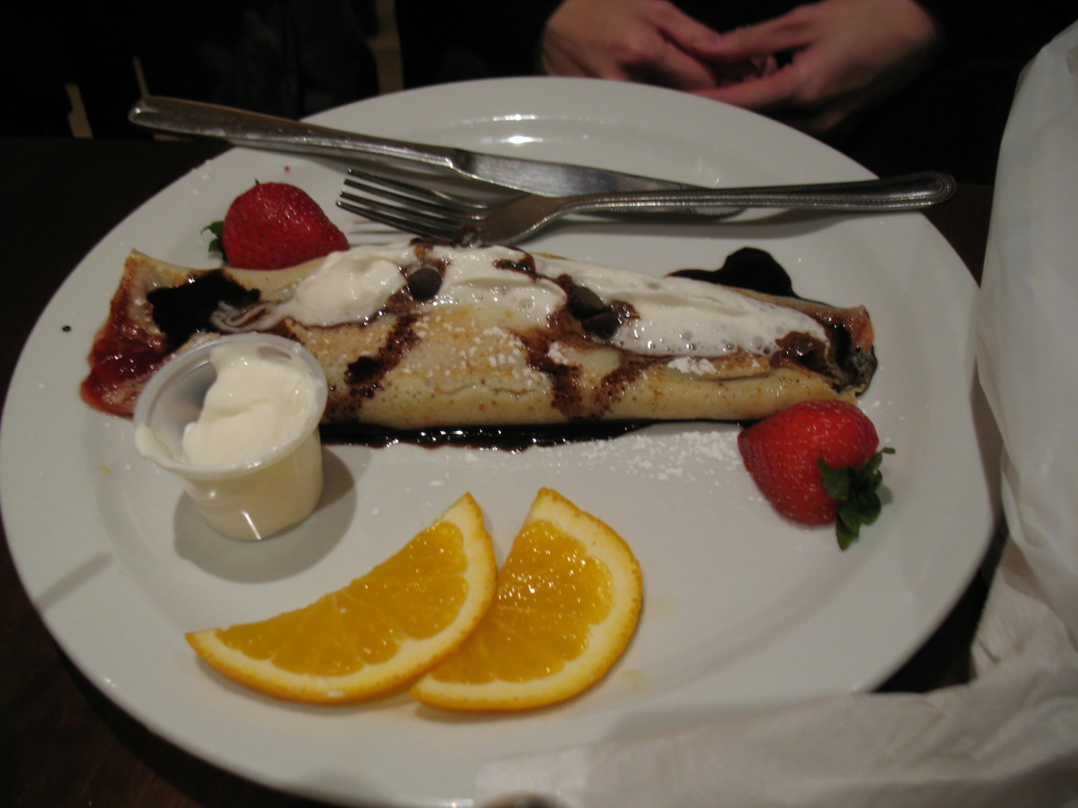 there is a plate with orange slices and strawberries