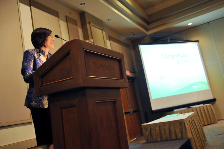 a person standing at a podium giving a speech