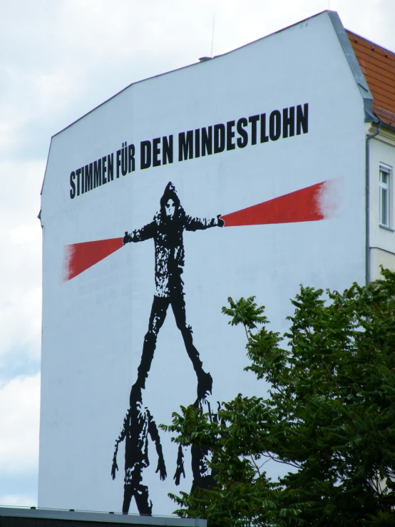 a poster of a man on a pole has been put on a building