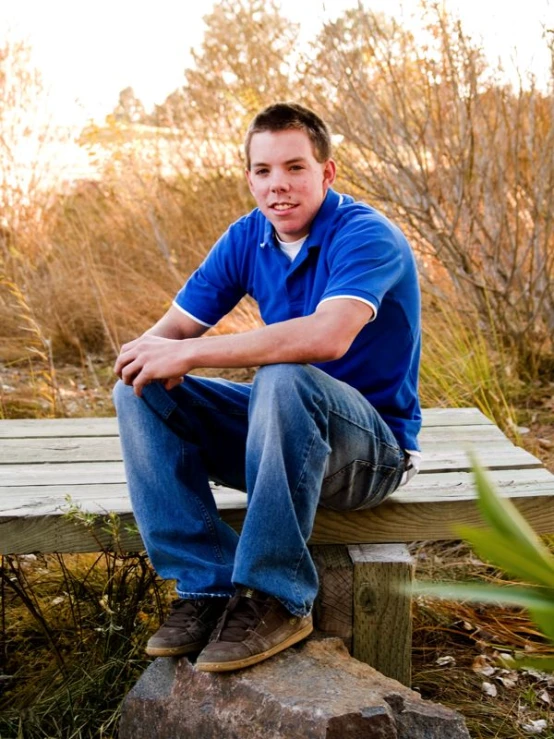 the man is sitting down on a bench