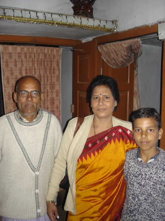 family posing for picture in a room with wooden closets