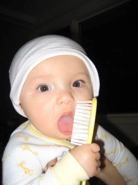 a young child with a plastic comb in his mouth