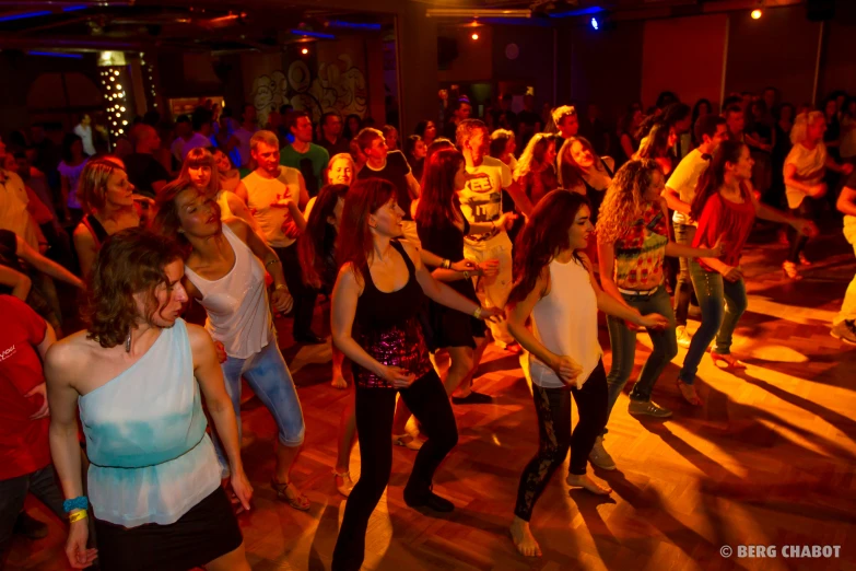 several women and men are having party at the dance