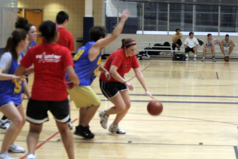 a group of girls on basketball court playing ball