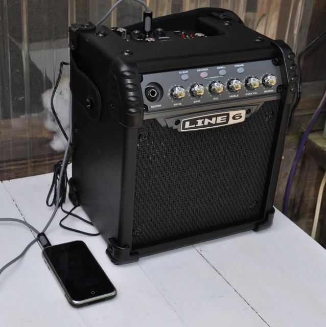 a small guitar amplifier with an iphone by it