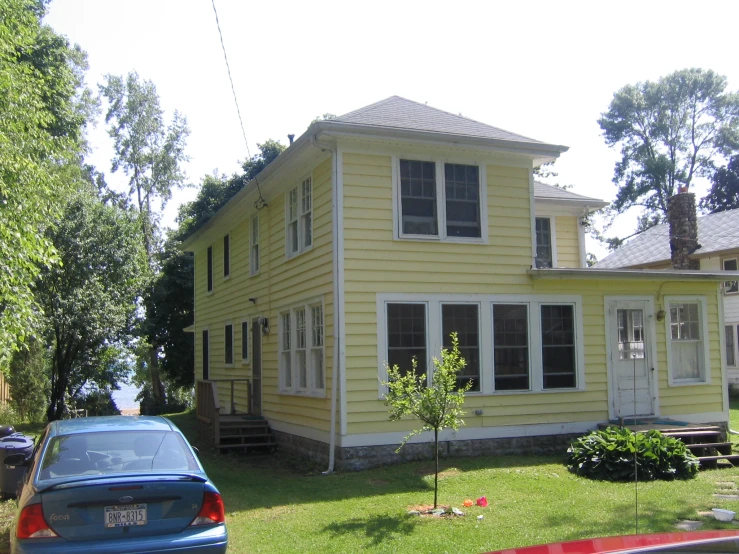 a car parked in front of a home on the side of a street