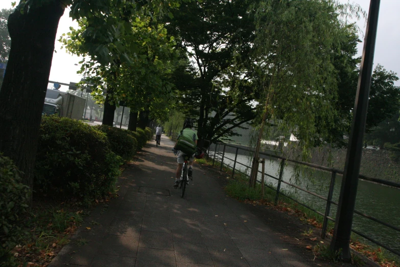 a person riding a bike on a paved path