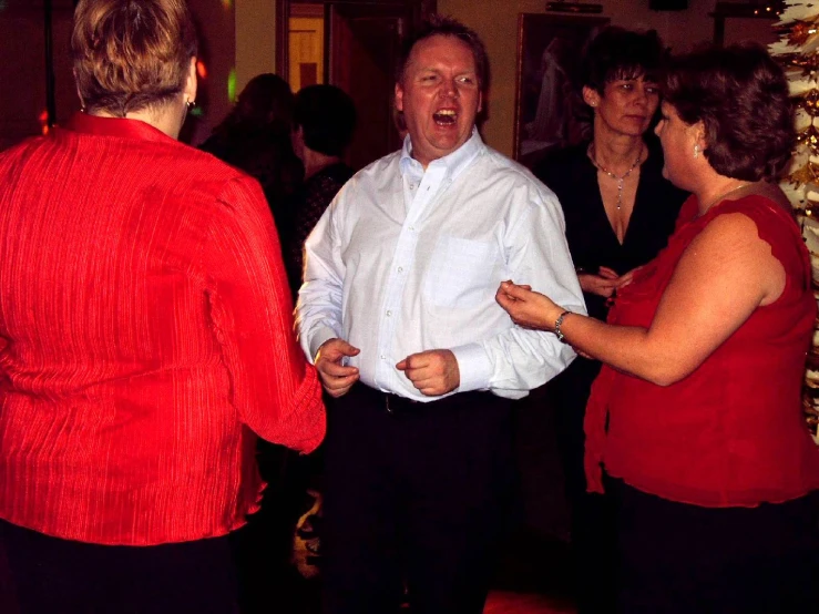 a man standing with a group of people around him