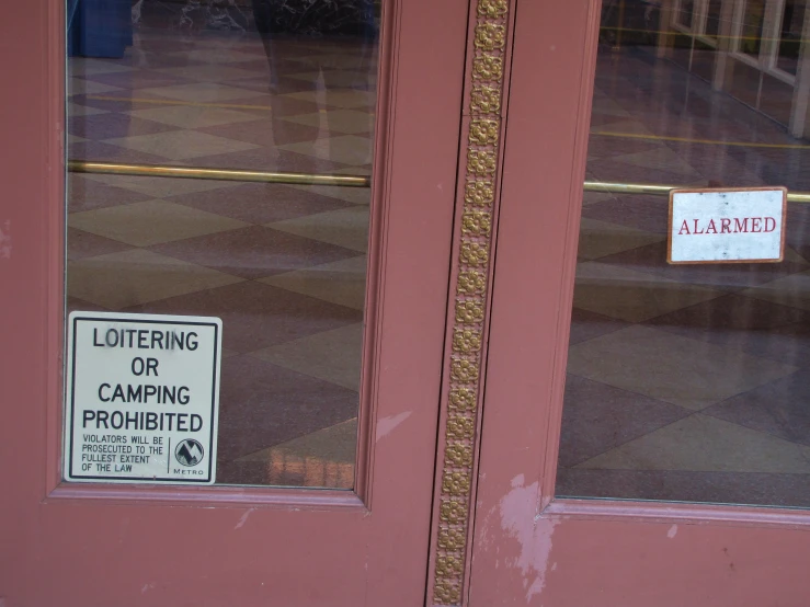 the sign is hanging on the glass door