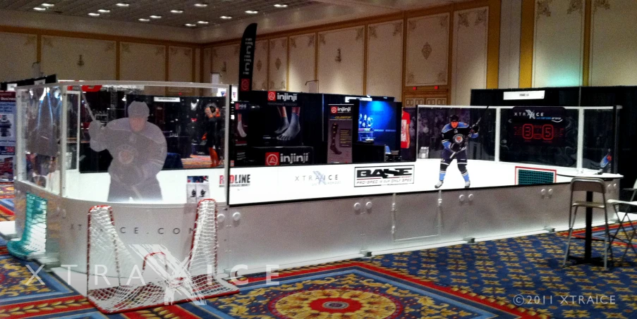 a man standing behind a display case for an iphone device