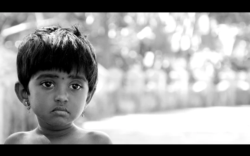 a black and white po of a little boy with big blue eyes