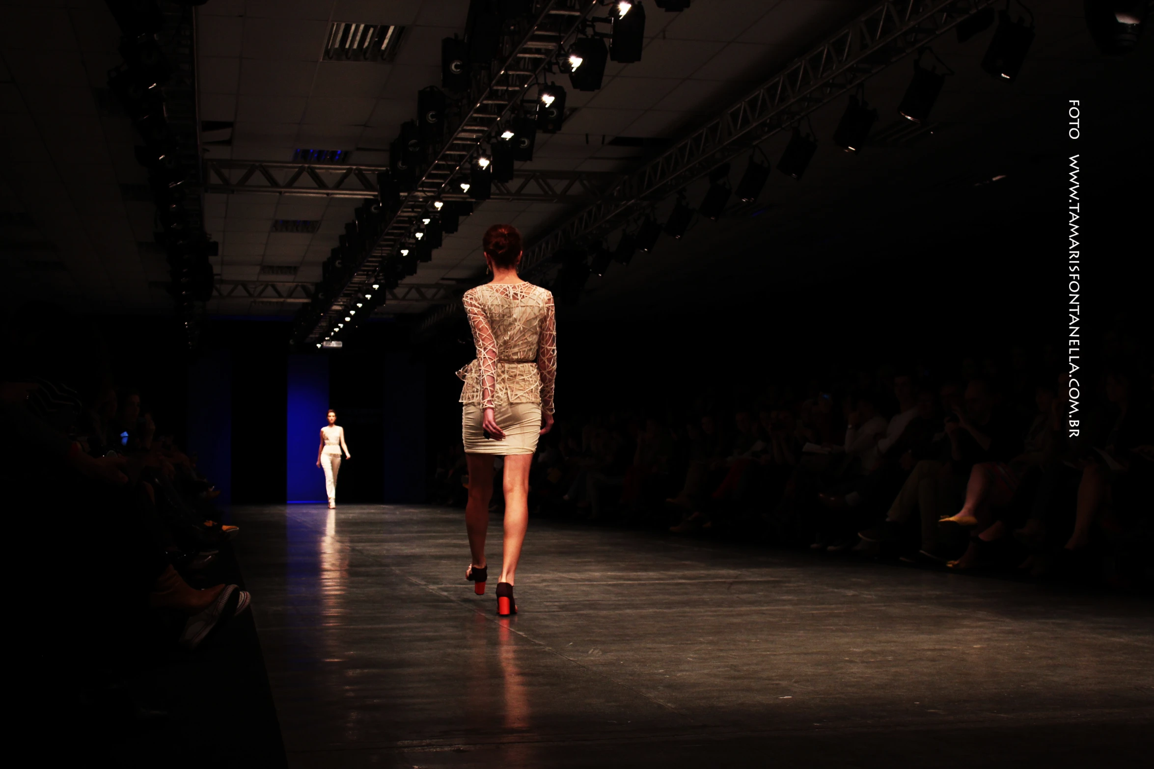 a model walks down the runway of a fashion show