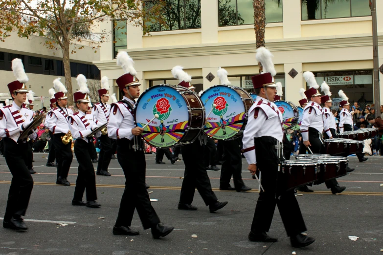 a parade is being carried down the street by people wearing costumes