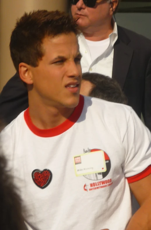 a man is standing behind another man while holding a frisbee