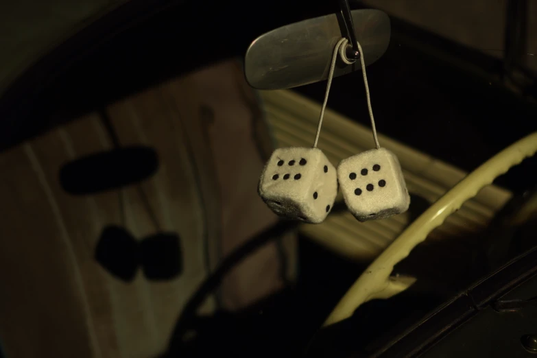 two dices attached to string to a car