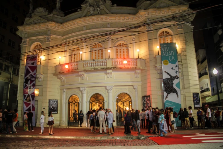 the facade of a building with many people standing outside