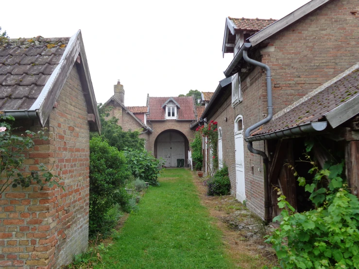 a narrow alley with houses along each side