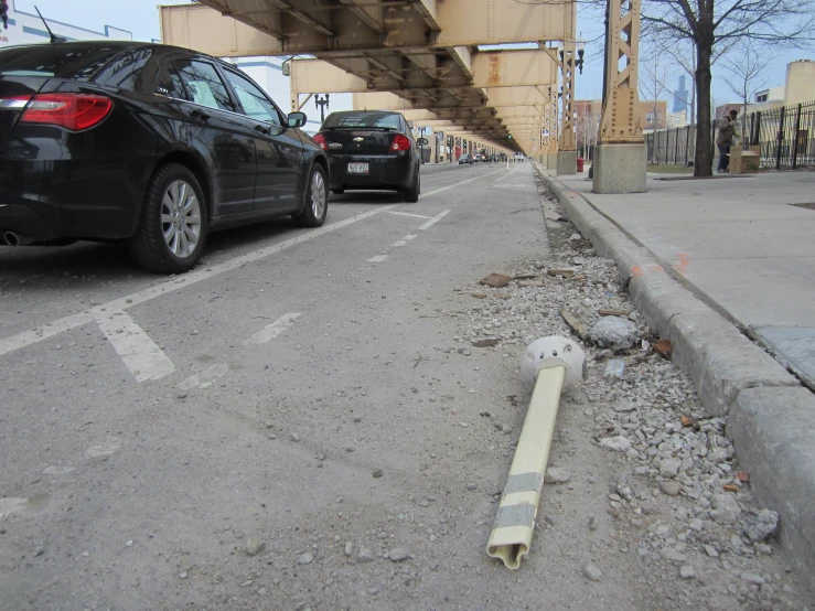 the concrete is near the road and cars are parked