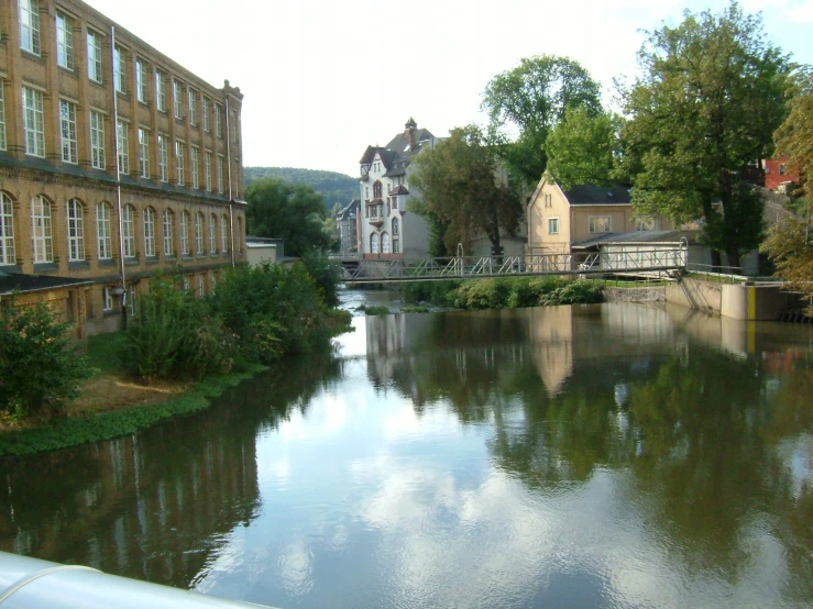 a river is seen along a city street