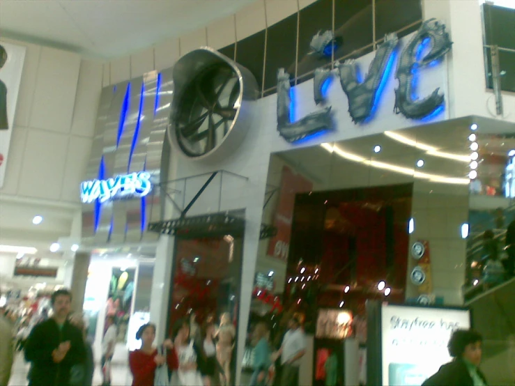 people walk around inside of a shopping center