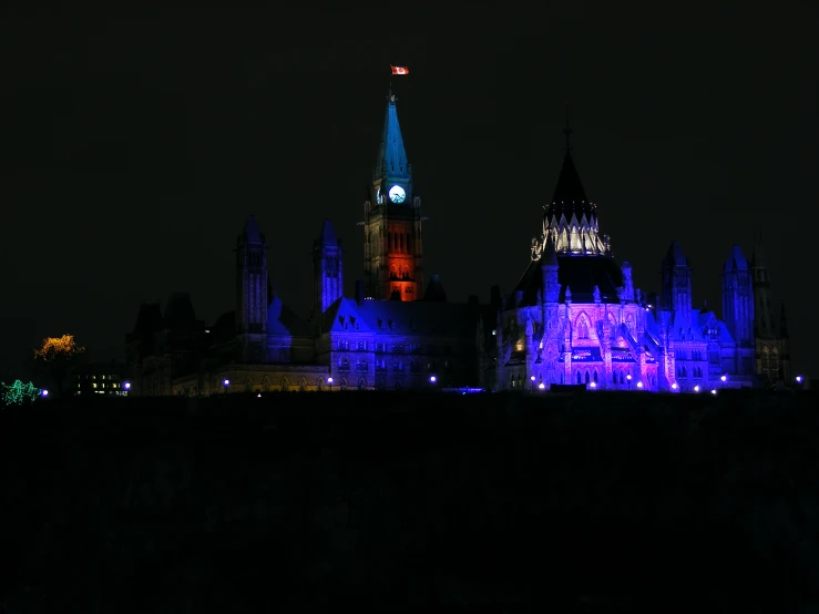 lit up gothic gothic buildings at night time