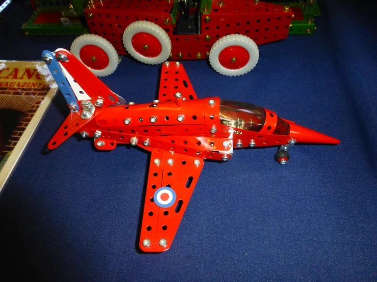 a toy airplane is next to a book