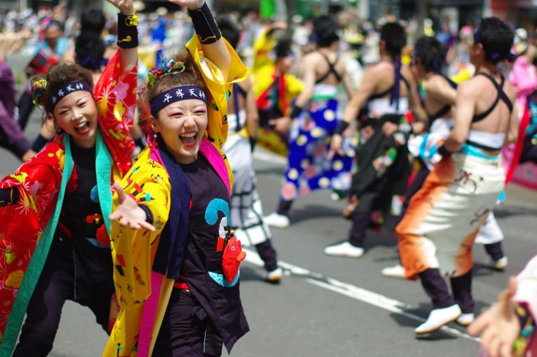 two women in costumes are smiling as they dance